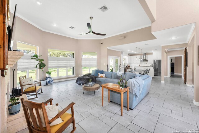 living room featuring ceiling fan and ornamental molding