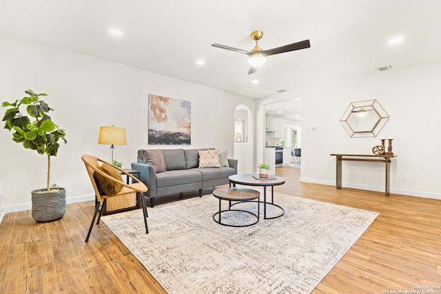 living room featuring hardwood / wood-style flooring and ceiling fan