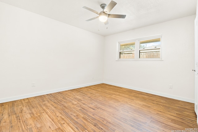 spare room featuring ceiling fan and light wood-type flooring