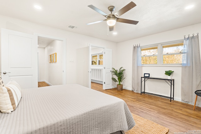 bedroom featuring ceiling fan and light hardwood / wood-style flooring