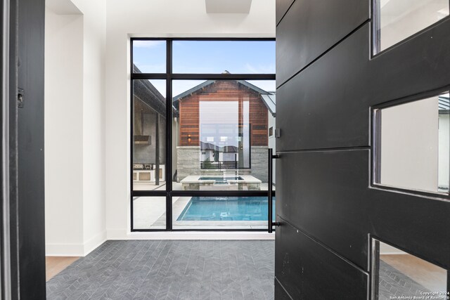 doorway to outside with a healthy amount of sunlight and hardwood / wood-style flooring