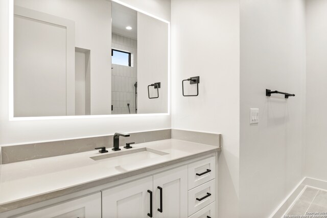 bathroom featuring tile patterned flooring and vanity