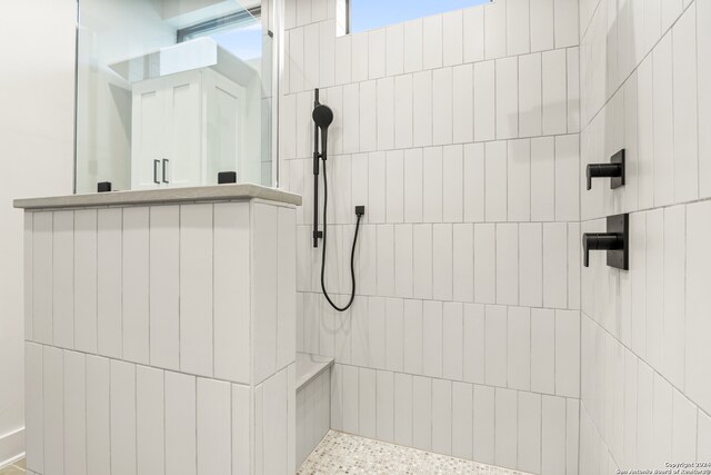 bathroom with tiled shower