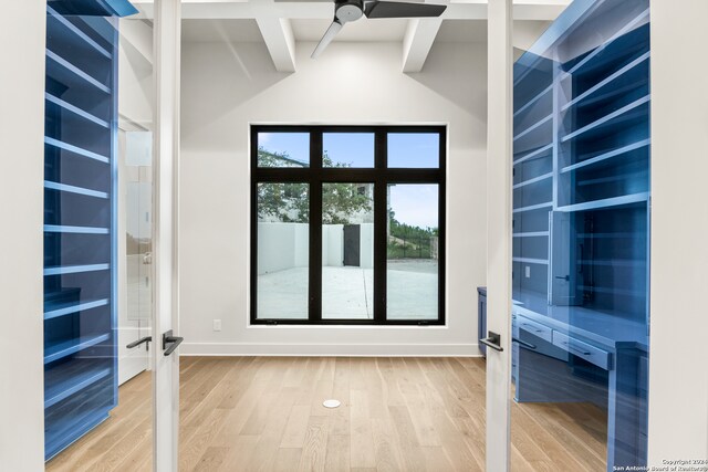 entryway with french doors, beam ceiling, ceiling fan, and wood-type flooring