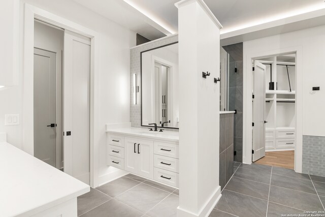 bathroom with vanity, tile patterned floors, and a shower with door