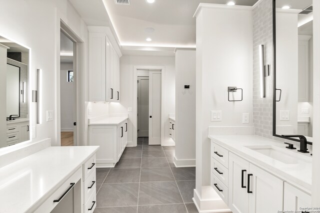 bathroom featuring tile patterned flooring and vanity