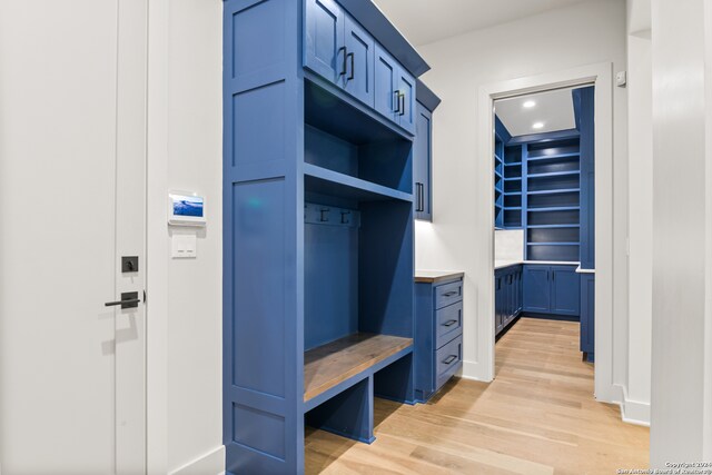 mudroom with light hardwood / wood-style flooring