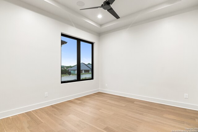 spare room with light wood-type flooring and ceiling fan