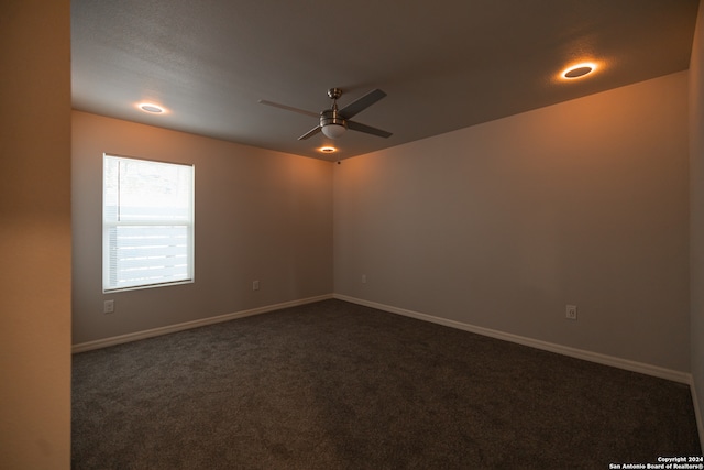 carpeted spare room featuring ceiling fan