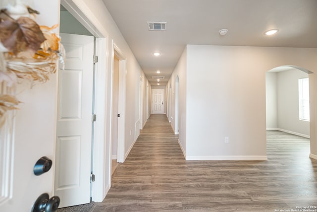 corridor with hardwood / wood-style floors