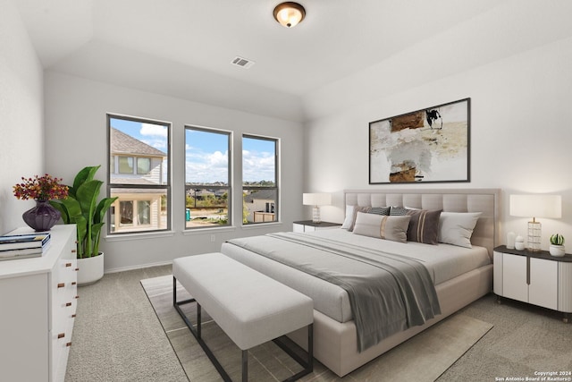 carpeted bedroom with vaulted ceiling