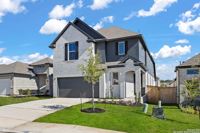 view of front facade featuring a front lawn and a garage