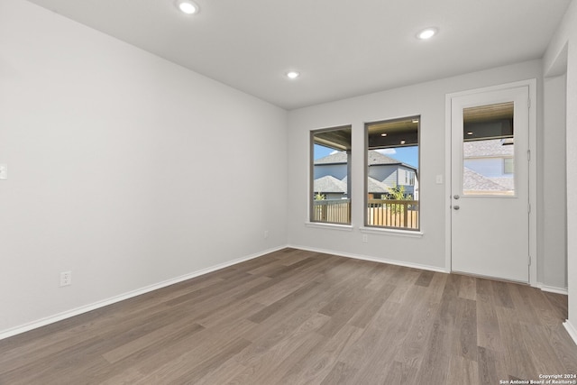 unfurnished room featuring hardwood / wood-style flooring