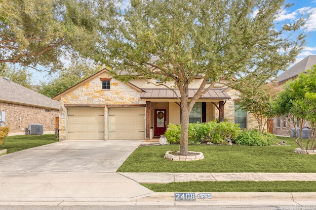 view of front of property with central AC unit, a garage, and a front lawn