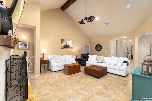 living room featuring beamed ceiling and high vaulted ceiling