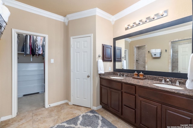 bathroom featuring a shower, crown molding, tile patterned floors, and vanity