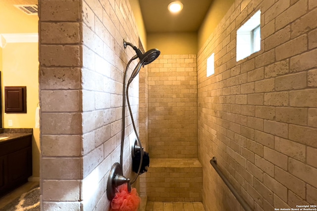 bathroom with vanity and tiled shower