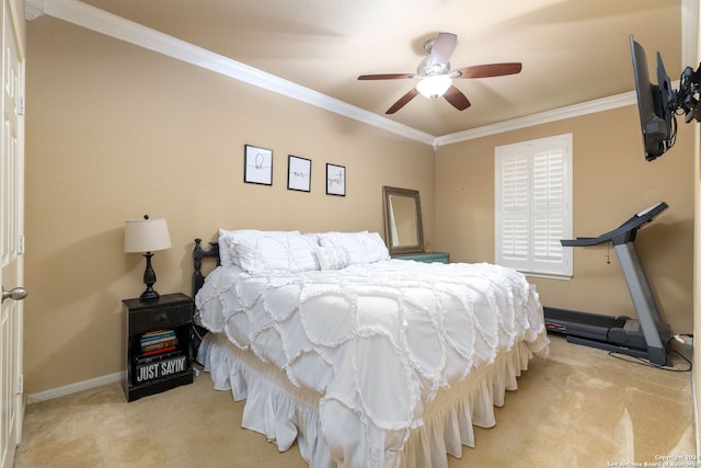 carpeted bedroom with ceiling fan and crown molding