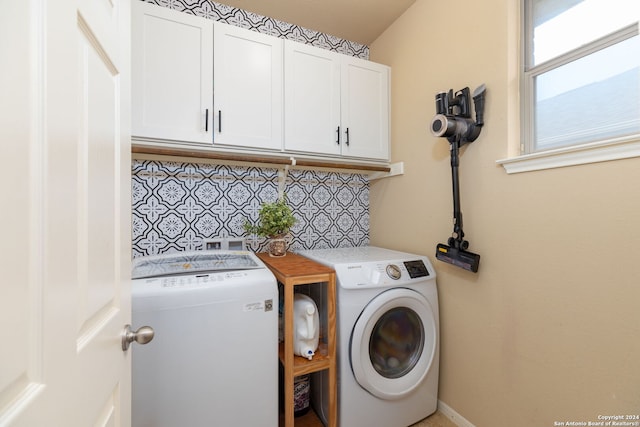 washroom with cabinets and washer and clothes dryer