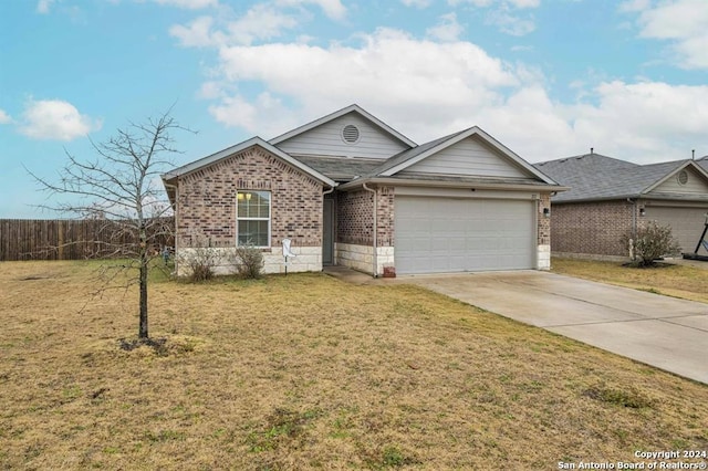 ranch-style house featuring a garage and a front yard