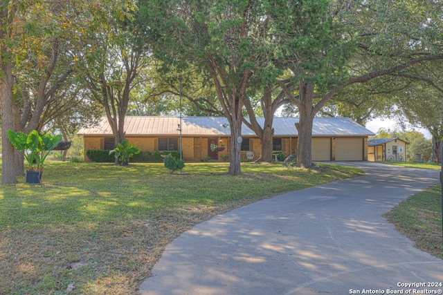 ranch-style house with a front yard and a garage