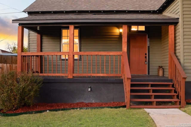 exterior entry at dusk with a porch