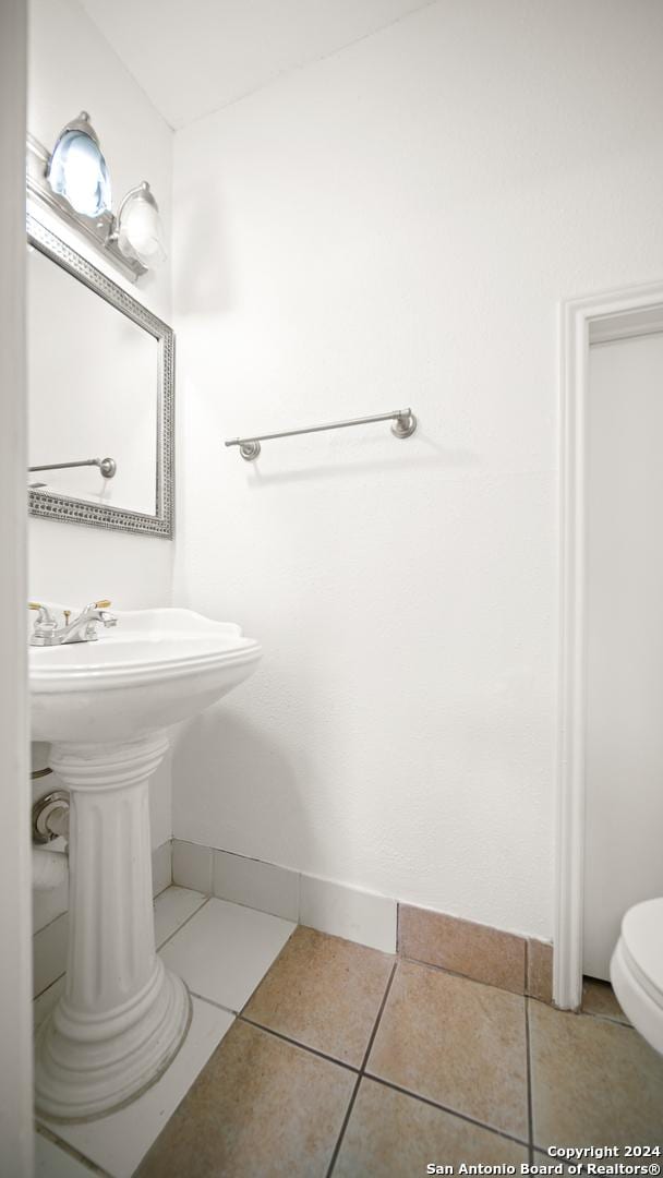 bathroom with tile patterned flooring and toilet