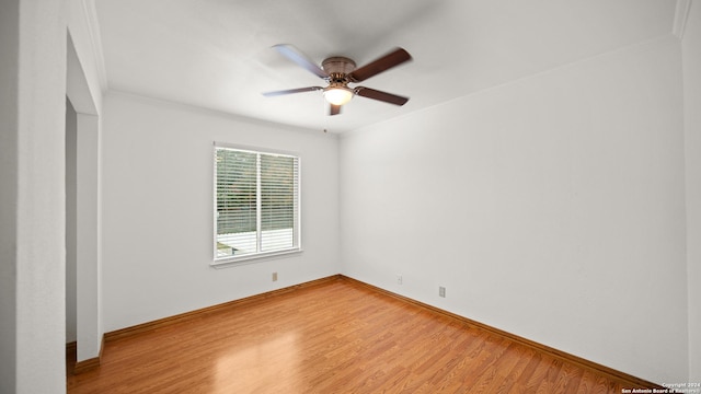 unfurnished room with hardwood / wood-style flooring, ceiling fan, and ornamental molding