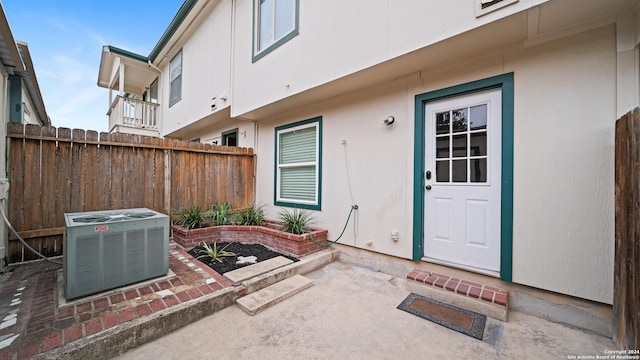 doorway to property featuring central AC unit