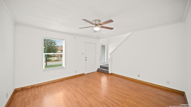 empty room with crown molding, ceiling fan, and light hardwood / wood-style floors