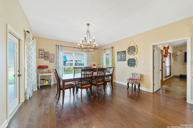 dining space featuring dark hardwood / wood-style floors and a notable chandelier