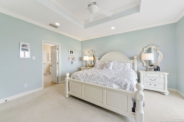 carpeted bedroom featuring a tray ceiling, ceiling fan, and crown molding