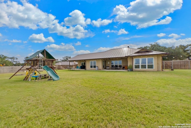 exterior space with a playground and a lawn