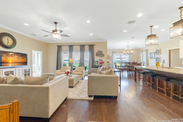 living room featuring ceiling fan, dark hardwood / wood-style flooring, ornamental molding, and sink