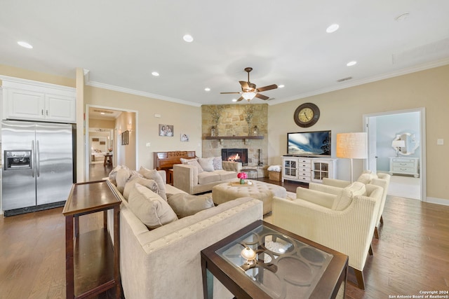 living room featuring a fireplace, ceiling fan, dark hardwood / wood-style flooring, and crown molding