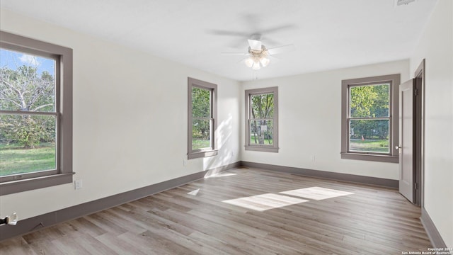603 E Cedar St, Seguin, TX 78155 - unfurnished room with a ceiling fan, wood finished floors, and baseboards