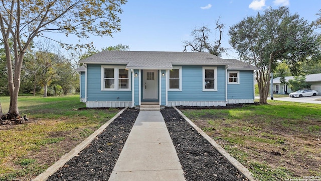 603 E Cedar St, Seguin, TX 78155 - view of front of home with a front yard and roof with shingles