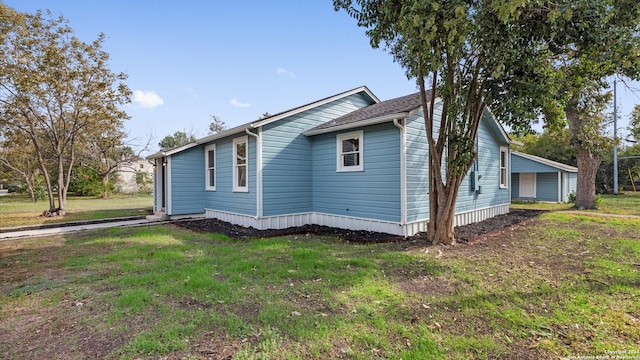 view of side of home featuring a lawn