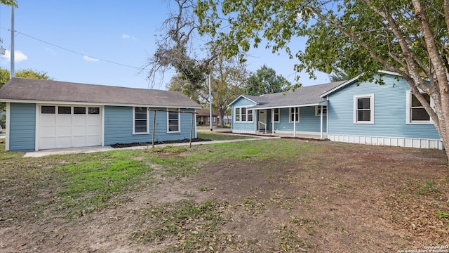 single story home featuring a porch and a garage