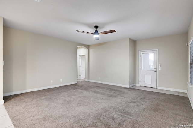 spare room with light colored carpet and ceiling fan