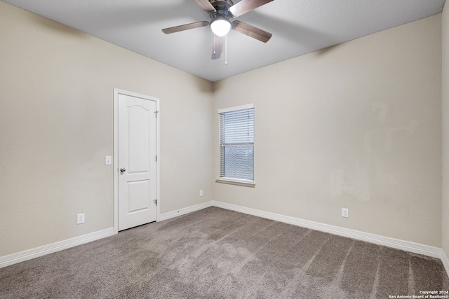 carpeted spare room featuring ceiling fan