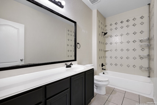 full bathroom with tile patterned flooring, vanity, tiled shower / bath combo, and toilet