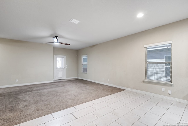 carpeted spare room with ceiling fan