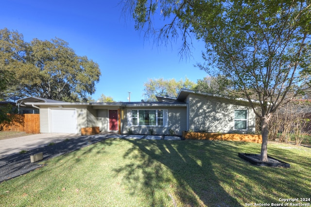 single story home with a garage and a front lawn