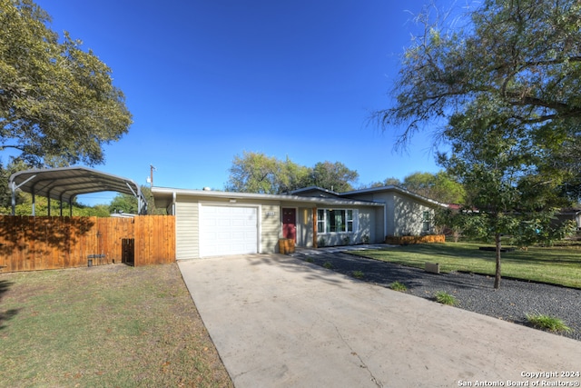 single story home featuring a carport, a garage, and a front yard