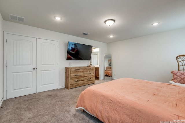 bedroom featuring light carpet and a closet