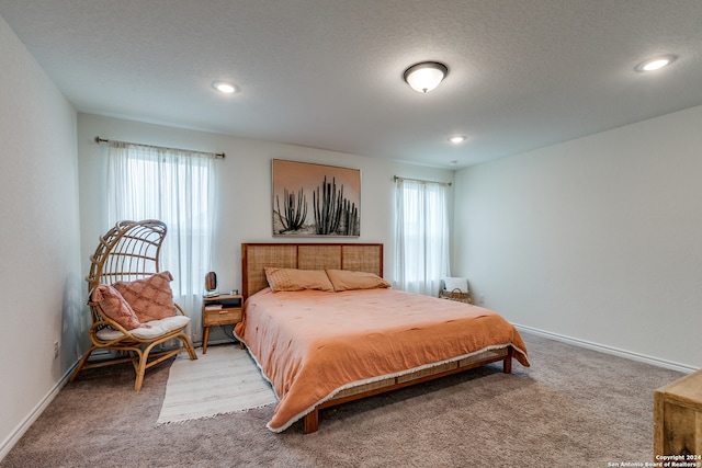 carpeted bedroom featuring a textured ceiling