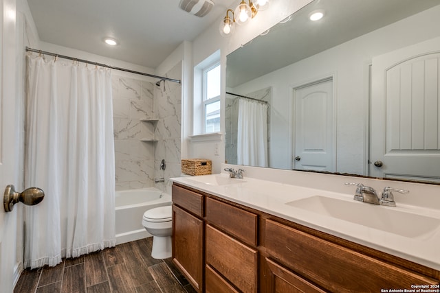 full bathroom featuring hardwood / wood-style floors, vanity, toilet, and shower / bath combo with shower curtain