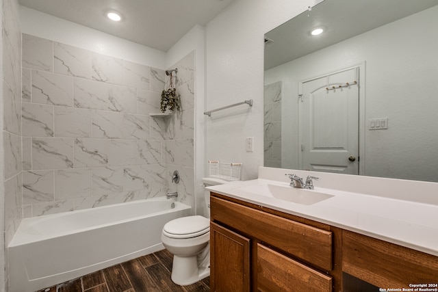 full bathroom with toilet, vanity, wood-type flooring, and tiled shower / bath