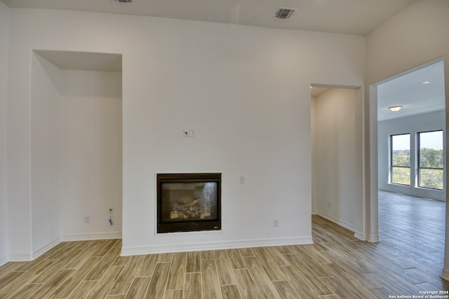 unfurnished living room featuring light wood-type flooring